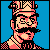 Pixel art portrait of a mustached character with checkered patterns on headwear and clothing against solid blue background, rendered in retro 8-bit style with limited color palette.