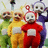 Pixelated image of four Teletubbies characters in colored onesies with a grassy background and overlaid text reading "Straight Outta Compton".
