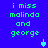 Blue background with green pixelated text reading "i miss malinda and george" in two vertical , featuring a small blue downward-pointing arrow icon that alternates between solid and hollow states