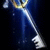 A pixelated blue and white figure with a glowing yellow circular element near the head, set against a dark background.