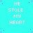 Cyan background with repeated white text 'HE STOLE MY HEART' in pixelated font, scattered pink dots, and a gray rectangle at bottom right.