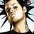Pixelated static image of a person's face with spiky dark hair and light skin, set against a white background with black radial lines.