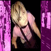 A person with light brown hair in a pink shirt and dark suspenders leans forward against a black background with purple side panels.