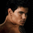 A shirtless man with dark hair appears in three sequential views against a black background, each showing a slight shift in head position.