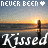 A pixelated sunset scene with a wooden post in water, text reading 'NEVER BEEN' and 'Kissed', two heart symbols differing between frames.