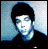 Pixelated static image of a person with dark hair and light skin against a blue-gray background, rendered in low-resolution 256x256 pixels with visible dithering and color banding.