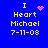 Blue background with yellow text reading "I Heart Michael 7-11-03" and four variations of pink pixelated heart or star symbols.