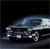 Pixelated image of a silver sedan with dark windows, viewed from a low angle against a black background, showing front and side details.