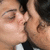 Two people in close proximity with one person's hand near the other's face, rendered in pixelated style.