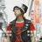 A pixelated static image shows a person with dark hair styled in two buns wearing a red top and black vest against a light background.