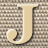 Static 48x48 pixel icon featuring a stylized beige letter J with black outline on a brown and white checkered background.