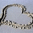 A pixelated circular frame with a broken, irregular outline in shades of gray and black against a light blue background.