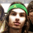 A static pixelated image shows a person with long dark hair wearing a green headband, positioned against a blurred background with indistinct shapes.