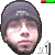A pixelated headshot of a person wearing a dark beanie with white text, displayed in multiple overlapping views against a gray background.