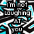 Pixelated text reads "I'm not Laughing AT YOU" and "I'm Laughing ABOUT YOU" over a black-and-white maze-like pattern with cyan accents.