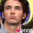 Static 48x48 pixel buddy icon featuring a close-up of a person with dark hair, pink lips, and visible facial features against a yellow background with blue/purple accents; text "KEVIN" in white block letters with a red heart symbol below the name.