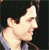 Pixelated profile view of a person with light skin tone, closed eyes, and dark hair against a dark background.