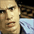 Pixelated image of a person with dark hair and a light blue shirt next to a Spider-Man character in red and blue costume with white eyes.