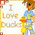 Pixel art icon with orange text 'I Love Ducks' on white background, featuring a character in blue pajamas holding a yellow duck.