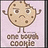 Pixelated cookie character with brown spots, arms raised, standing on two legs against light purple background.