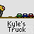 Yellow truck with large gray tires and red accents moves across brown ground, pushing small green-blue-red objects while text 'Kyle's Truck' appears below.