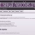 Pixelated static image showing a horizontal bar of purple and white squares above a white background with gray rectangular shapes.