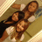 Three people pose together in a pixelated image with visible color shifts across frames.