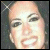 A 50x50 pixel animated contact sheet showing two sequential frames of a woman's face with subtle expression changes, featuring sparkles in the top corners and a gray background.