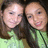 Two individuals with light skin tones and brown hair wearing green tops, positioned side-by-side in a pixelated static image.