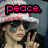 A pixelated image of a person wearing a pink-and-white striped hat and dark sunglasses, making a peace sign with their right hand.