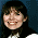 A pixelated image divided into four quadrants showing a person with dark hair, a blue background with yellow symbols, a yellow background with a blue butterfly, and a gray background.