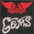 Red winged figure with outstretched arms above stylized silver text on dark background.