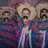 Three figures in sombreros and striped ponchos stand against a dark background with text overlays.