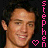 A 3x3 contact sheet of eight animated frames showing a young man's face with varying expressions, surrounded by vertical pink text and heart symbols on a black background.