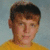 A pixelated portrait of a person in a yellow shirt against a light blue background, next to red text on black reading 'r.i.p. ken we love & miss you'.