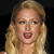 Pixelated close-up of a person with long blonde hair against a black background, mouth open in a shouting expression.