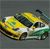 Pixelated yellow and green vehicle with dark accents on a gray background, appearing as a static digital icon.