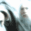 A pixelated animated sequence shows a figure with long hair and dark clothing against a light background, transitioning from profile to front view.