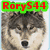 A four- shows a wolf's face with overlaid text: 'RoryS44' top-left, 'loves' top-right, 'monster enegey' bottom-left. The wolf has brown and white fur, closed eyes, and a black nose. The background is pixelated green and brown. The text is red with green outlines. The image is static with no animation