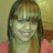 Pixelated static image of a person with long brown hair wearing a pink top against a muted yellow background.