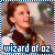 Pixelated image of a person with brown hair in a white and dark outfit, bordered by blue-and-white stripes, with text reading 'wizard of oz' at the bottom.