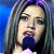 A pixelated contact sheet showing two frames of an animated icon featuring a woman singing into a microphone on the left and green text reading "Original Icons .com" on the right against a dark background.