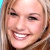 Pixelated close-up of a smiling person with light brown hair and visible teeth, rendered in low-resolution 50x50 pixels on a transparent background.