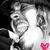 Pixelated grayscale image of a person's face with a bright white highlight on the right side and a small pink heart symbol in the bottom-right corner.