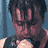 A man with dark hair sings into a microphone in multiple poses against blue and black backgrounds, one frame shows an orange flame effect.