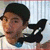 A pixelated image of a person with dark hair wearing a white shirt, with a black and white bird-like figure behind them and text overlay reading 'it's a whale!' in two lines.