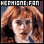 Pixelated image of a person with red hair and blue eyes, wearing a dark top with a blue collar, under text reading HERMIONE FAN.