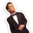 Pixelated image of a person in a black tuxedo with white bow tie, arms crossed, head tilted back against white background.