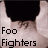 Static pixelated icon showing a partial view of a person's lower body with text "Foo Fighters" below, set against a light background.