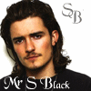 Two side-by-side identical images of a person with long brown hair and mustache, wearing black shirt with 'Mr S Black' text, against white background.